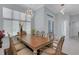 Elegant dining area featuring a grand table setting, modern chandelier, and ample natural light at 1596 Landfall Dr, Nokomis, FL 34275