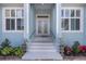 Elegant home entrance with double doors, white trim, and meticulously manicured landscaping for added curb appeal at 1596 Landfall Dr, Nokomis, FL 34275