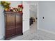 Inviting entryway with a decorative cabinet and a glimpse into the home's interior at 1596 Landfall Dr, Nokomis, FL 34275