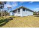 Charming exterior view of the home featuring a screened lanai and lush green lawn at 1596 Landfall Dr, Nokomis, FL 34275