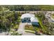 Captivating home featuring a pristine metal roof, well-manicured lawn, and an inviting brick driveway at 1596 Landfall Dr, Nokomis, FL 34275