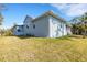 This exterior view features a well-manicured lawn and a screened lanai, creating a welcoming outdoor space at 1596 Landfall Dr, Nokomis, FL 34275