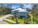 Inviting home featuring a bright blue exterior, a well-kept lawn, and a paved driveway for added curb appeal at 1596 Landfall Dr, Nokomis, FL 34275