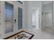 Bright foyer featuring tile floors, double glass doors, and access to other rooms at 1596 Landfall Dr, Nokomis, FL 34275