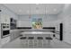 Bright kitchen features an island with seating, stainless appliances and modern cabinetry at 1596 Landfall Dr, Nokomis, FL 34275