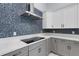 Updated kitchen features mosaic backsplash, stainless vent hood, and sleek cooktop at 1596 Landfall Dr, Nokomis, FL 34275