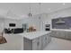Spacious kitchen features island with plenty of cabinets and is adjacent to the living room at 1596 Landfall Dr, Nokomis, FL 34275