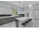 Modern kitchen with large island, stainless appliances, gray and white cabinets and view to the exterior at 1596 Landfall Dr, Nokomis, FL 34275