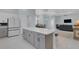 Open kitchen and living area includes large center island, seating and plenty of counter space at 1596 Landfall Dr, Nokomis, FL 34275