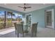 Screened lanai features a ceiling fan and dining area, offering an inviting space for outdoor meals and relaxation at 1596 Landfall Dr, Nokomis, FL 34275