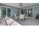 The screened lanai boasts a dining area and seamless indoor-outdoor flow through sliding glass doors at 1596 Landfall Dr, Nokomis, FL 34275