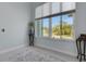 Bright living room featuring a large window offering natural light and serene views at 1596 Landfall Dr, Nokomis, FL 34275