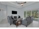 Comfortable living room with neutral decor, tile floors, and sliding doors to the lanai at 1596 Landfall Dr, Nokomis, FL 34275