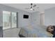 Bright bedroom with sliding glass doors, flat screen TV and light-colored tile floors at 1596 Landfall Dr, Nokomis, FL 34275