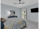 Bright bedroom with sliding glass doors, flat screen TV and light-colored tile floors at 1596 Landfall Dr, Nokomis, FL 34275