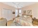 Cozy bedroom with neutral walls, ceiling fan, and natural light at 1723 San Silvestro Dr, Venice, FL 34285