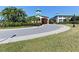 Clubhouse entrance with covered portico, circular driveway, and well-manicured landscaping at 1723 San Silvestro Dr, Venice, FL 34285