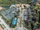 Aerial view of community amenities featuring tennis, pickleball, pool, clubhouse, parking, and landscaping at 190 Montelluna Dr # North, North Venice, FL 34275