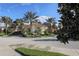 The community clubhouse welcomes with towering palm trees, landscaped grounds, and a grand entrance at 190 Montelluna Dr # North, North Venice, FL 34275