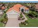 Charming home with a red tile roof, two-car garage, lush landscaping, and inviting curb appeal at 190 Montelluna Dr # North, North Venice, FL 34275