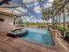 A refreshing screened-in pool and spa offer a serene outdoor retreat with views of the lush landscaping at 190 Montelluna Dr # North, North Venice, FL 34275