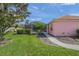 Well-maintained yard featuring lush landscaping, a pathway, and a screen enclosure to a pristine pool in the backyard at 1904 Canary Island St, Venice, FL 34292