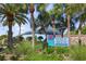 Picturesque Venice Beach entrance with lush landscaping and swaying palm trees near the beach at 1904 Canary Island St, Venice, FL 34292