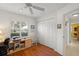 Bright bedroom featuring wood floors, a ceiling fan, a closet, and a window with natural light at 1904 Canary Island St, Venice, FL 34292