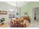 Bright dining room features a wooden table, six chairs, and a decorative chandelier at 1904 Canary Island St, Venice, FL 34292