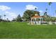 Expansive green space featuring a charming white gazebo, surrounded by lush grass and picturesque trees at 1904 Canary Island St, Venice, FL 34292