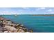 Scenic coastal view of jetty extending into turquoise water and a boat passing nearby at 1904 Canary Island St, Venice, FL 34292
