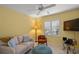 Relaxing living room with ample seating, a bright window, and a tiled floor at 1904 Canary Island St, Venice, FL 34292