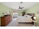 Inviting main bedroom with a decorative ceiling fan and sliding door to the pool area at 1904 Canary Island St, Venice, FL 34292