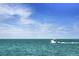 Picturesque view of a white speedboat speeding across tranquil, turquoise waters under a clear, blue sky at 1904 Canary Island St, Venice, FL 34292