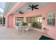 Enclosed patio with table and chairs for outdoor dining, with a view of the living room through sliding glass doors at 1904 Canary Island St, Venice, FL 34292