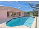 Gorgeous backyard featuring a screened-in pool with ample deck space and beautiful lush landscaping to enjoy the outdoors at 1904 Canary Island St, Venice, FL 34292