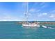 Beautiful view of a white sailboat navigating through clear, turquoise waters on a sunny day at 1904 Canary Island St, Venice, FL 34292