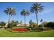 Well-manicured Islandwalk entrance sign framed by vibrant landscaping and palm trees at 19249 Isadora St, Venice, FL 34293