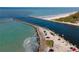 Aerial view of a coastal waterway, showing clear blue water, rocky breakwaters, and parked cars at 200 The Esplanade N # B10, Venice, FL 34285