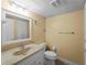Bathroom with cream colored walls and a single sink vanity with large mirror at 200 The Esplanade N # B10, Venice, FL 34285
