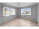 Bright bedroom with two large windows, light grey walls, and wood-look floors at 200 The Esplanade N # B10, Venice, FL 34285