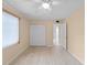 A bedroom featuring wood floors, a ceiling fan, a closet, and a neutral wall color at 200 The Esplanade N # B10, Venice, FL 34285