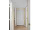 Hallway with neutral walls and wood floors, featuring a closet with folding doors at 200 The Esplanade N # B10, Venice, FL 34285