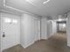 Hallway view highlighting the neutral carpeting and access to individual units at 200 The Esplanade N # B10, Venice, FL 34285