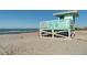 Turquoise lifeguard stand on a sandy beach overlooking the ocean at 200 The Esplanade N # B10, Venice, FL 34285