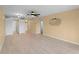 A living room with light walls, wood floors, a ceiling fan, and access to a kitchen area at 200 The Esplanade N # B10, Venice, FL 34285