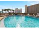 Sparkling community pool with lounge chairs and clear blue skies at 200 The Esplanade N # B10, Venice, FL 34285