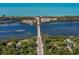 Scenic aerial view of the bridge and waterway, surrounded by lush greenery and ocean coastline at 26825 Weiskopf Dr, Englewood, FL 34223