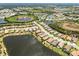 Beautiful aerial view of community featuring homes surrounding scenic lakes and lush green landscaping at 26825 Weiskopf Dr, Englewood, FL 34223