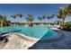 Community swimming pool with lounge chairs and cabanas at 26825 Weiskopf Dr, Englewood, FL 34223
